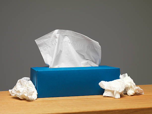 Tissue box on sideboard with used tissues