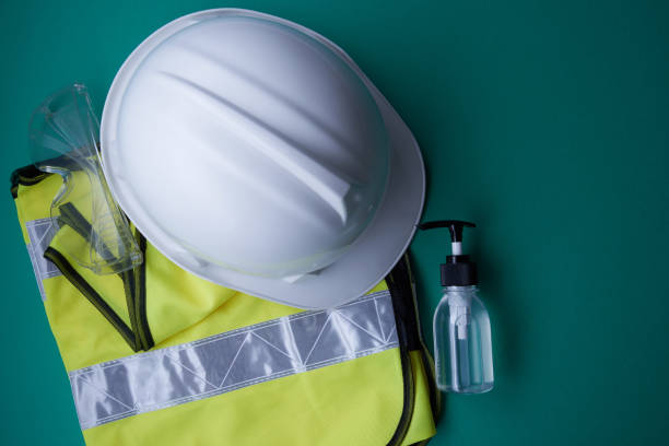 new normal of construction worker - helmet and hand sanitizer