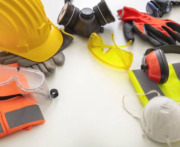 Work safety protection equipment flat lay. Industrial protective gear on white background, closeup view. Construction site health and safety concept