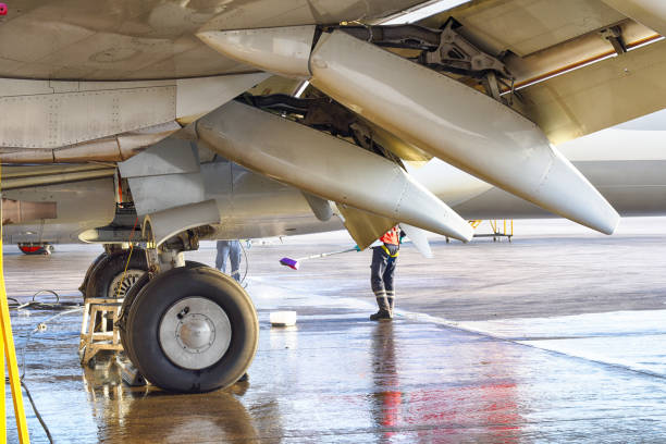 Airplane technician washing the plane